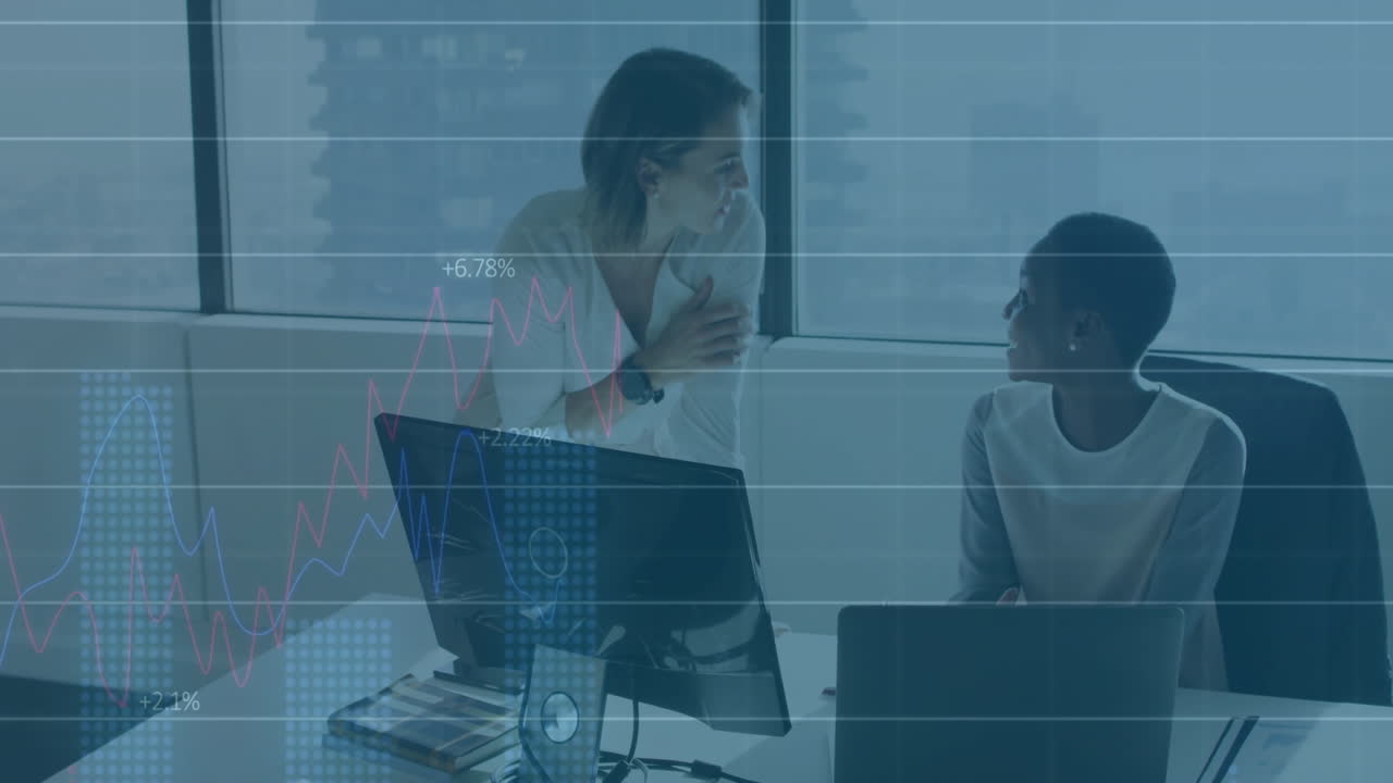 In office, businesswomen discussing financial data with animation charts overlay