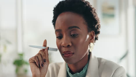 a woman thinking with a pen in her hand in an office
