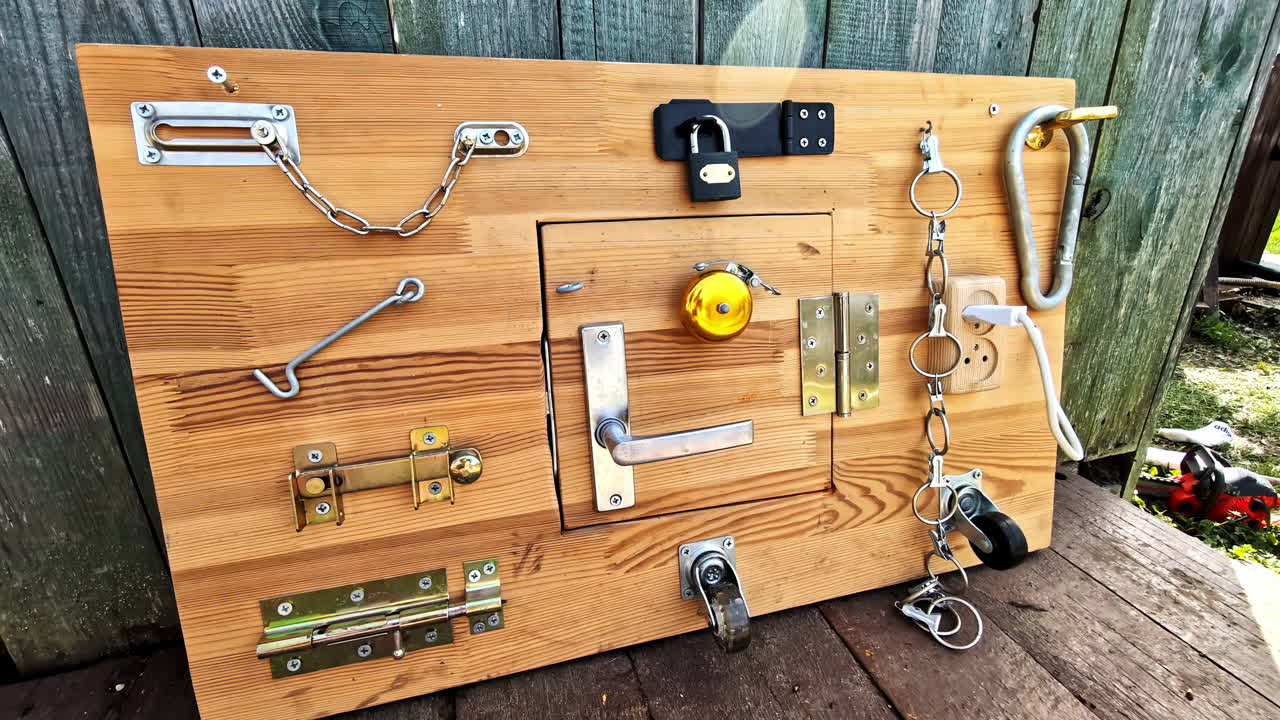Sensory board for children with locks and fasteners outdoors