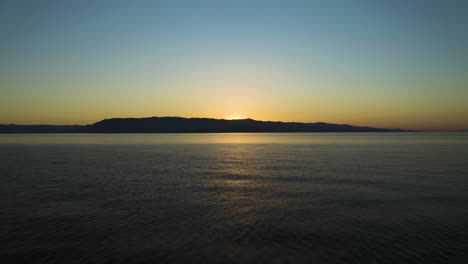 flyiing above flathead lake at sunset in summer in montana, usa