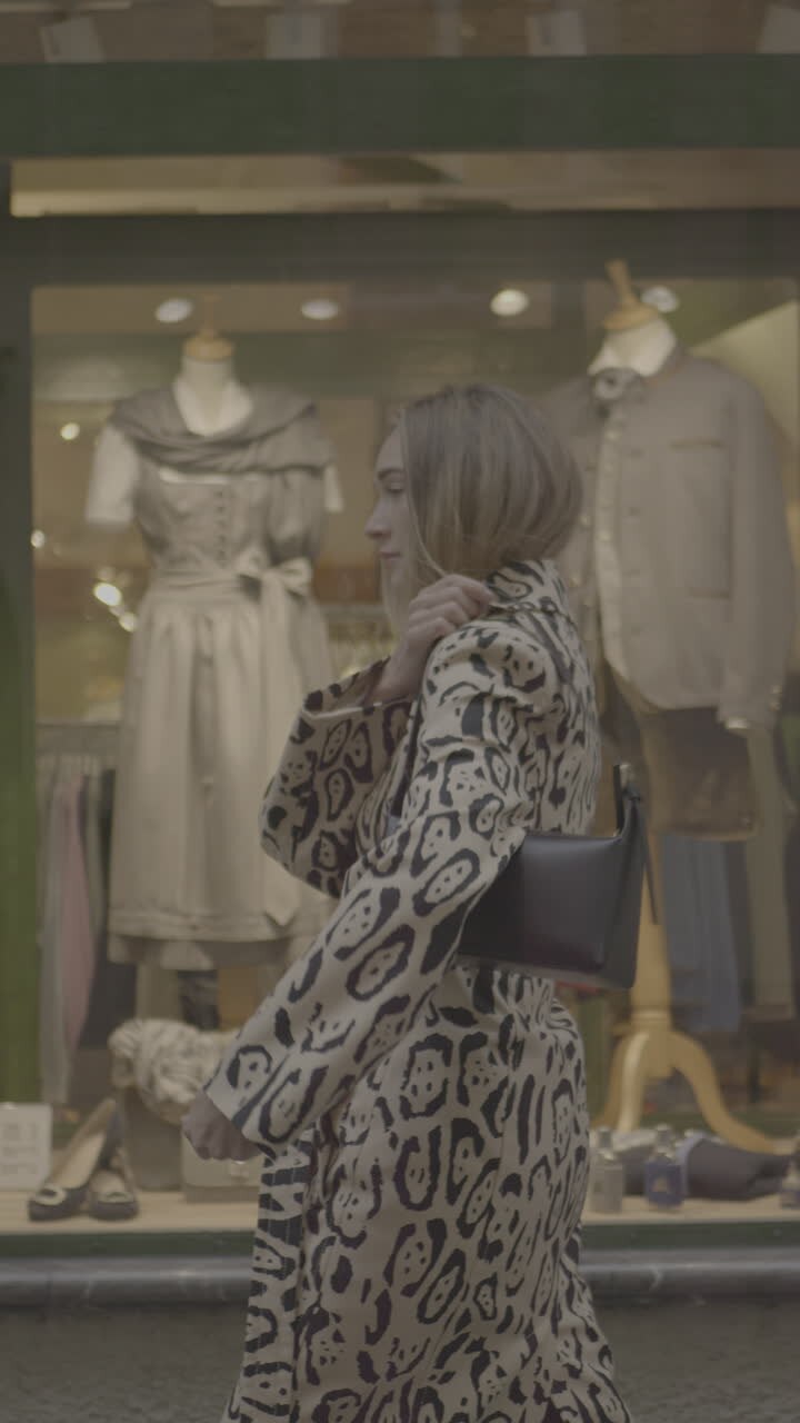 Woman in leopard print coat and bag, street style