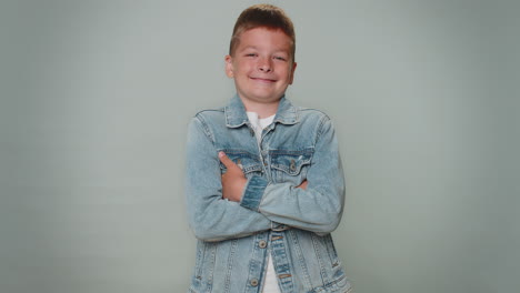 Cheerful-handsome-toddler-young-boy-fashion-model-in-jeans-jacket-smiling,-looking-at-camera-alone