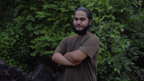 vivek bearded long hair man looking in camera smiling confident in jungle water