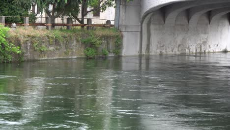 flowing water in cold river via old stone bridge.