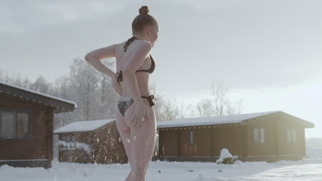 woman scrubbing his body with snow