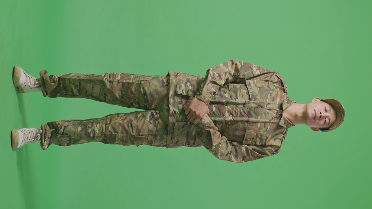 Full Body Of Asian Man Soldier Standing And Looking To Camera In The Green Screen Background Studio