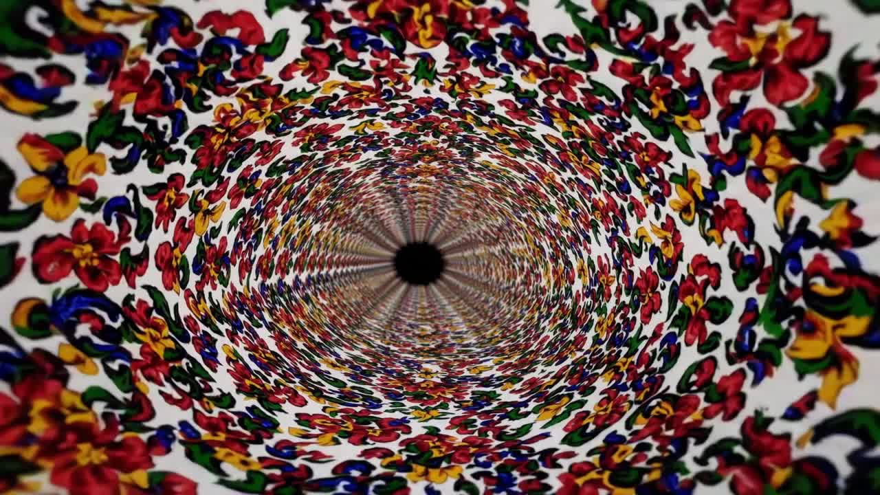Colorful floral pattern spirals inward, creating a mesmerizing visual effect, showcasing vibrant hues and intricate designs in a continuous motion sequence