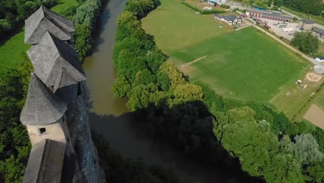 orava castle in slovakia from a distance, focused on the castle and nearby village, flying over, 50fps + 100ss