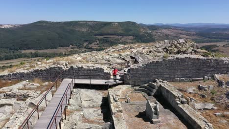 Retreating-drone-shot-above-the-ancient-city-of-Perperikon,-a-significant-historical-site-located-in-the-province-of-Kardzhali,-in-Bulgaria