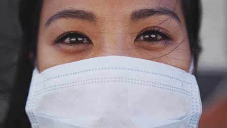 Woman-wearing-medical-coronavirus-mask-looking-at-camera