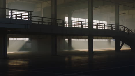 empty industrial space with sunlight and dust rays