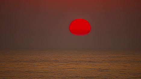 Tiro-De-Lapso-De-Tiempo-De-La-Colorida-Puesta-De-Sol-A-Lo-Largo-Del-Horizonte-En-El-Fondo-Sobre-El-Océano