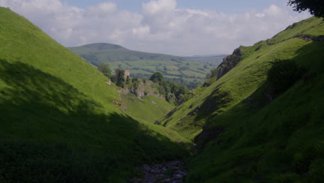 dramatic green valley with ancient castle ruins