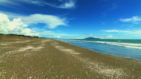 timelapse showing long white clouds over otaki beach, new zealand