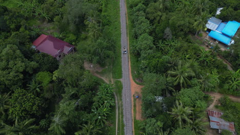 Railway-Cart-in-Cambodia-High-Angle-Descend-Over-Jungle