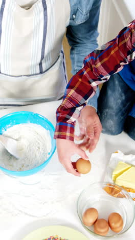 father and son preparing cupcake