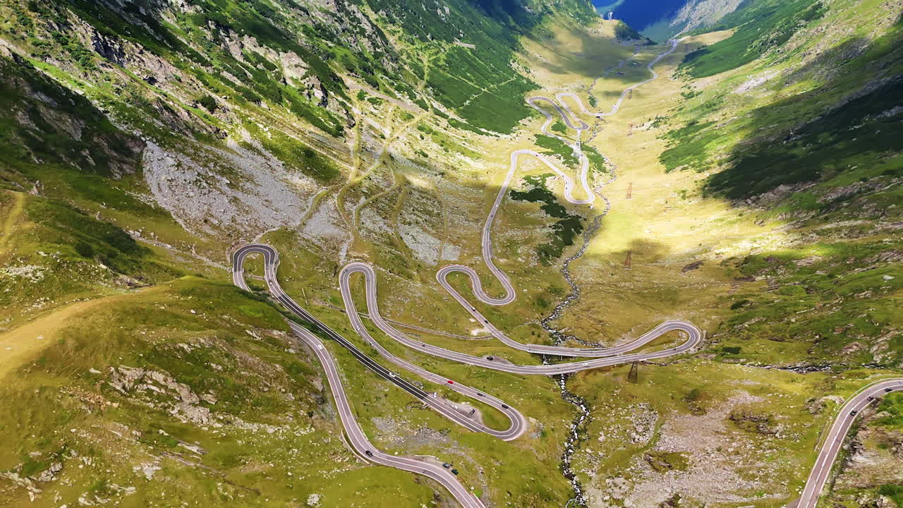 Transfagarasan road with sharp serpentines in Romania. Drone shot of the famous Transfagarasan highway with dramatic switchbacks in the Carpathian Mountains