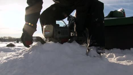 Ein-Mann-Verwendet-Einen-Eisbohrer-Zum-Eisangeln---Nahaufnahme