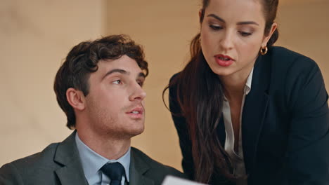 Serious colleagues analyzing business results in buro closeup. Office couple