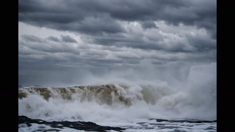 powerful waves crashing on the coastline during a storm