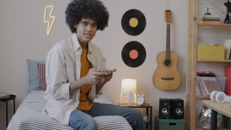teenager playing video games in bedroom