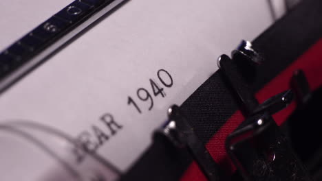 year 1940, typing on white paper in vintage typewriter, macro close up