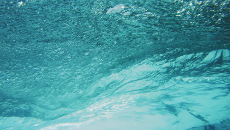 Rearview-of-tropical-paradise-with-white-sands-from-behind-barrel-of-wave