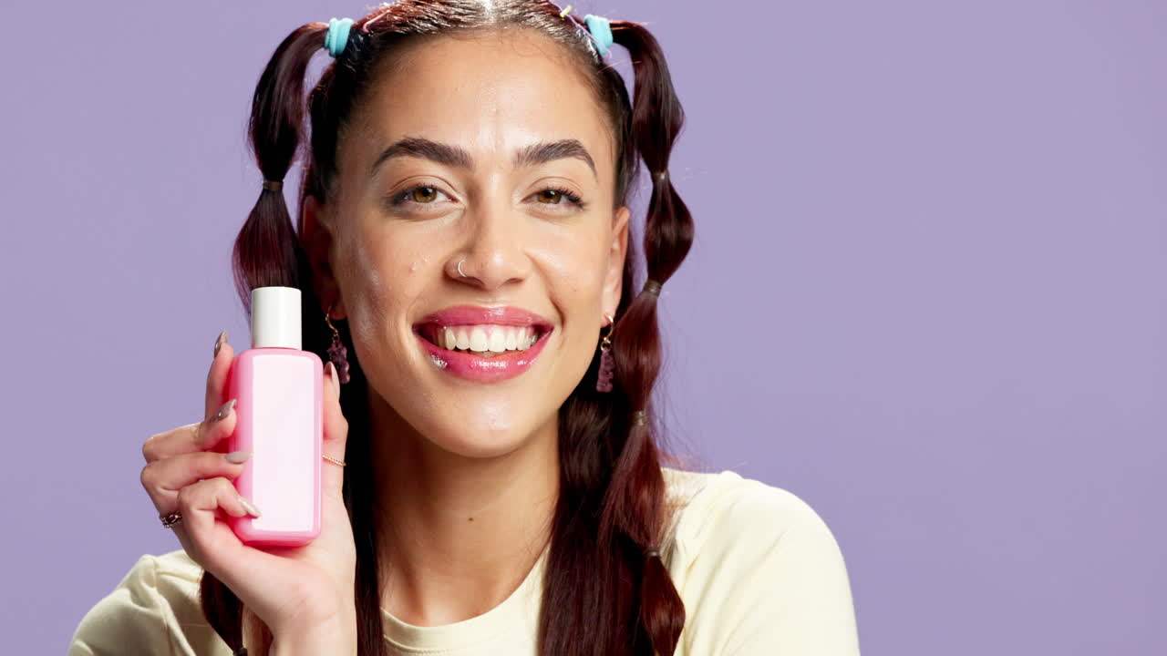 Woman holding a pink beauty product