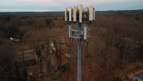 aerial shot rotating around cell phone tower in forest. 4k drone