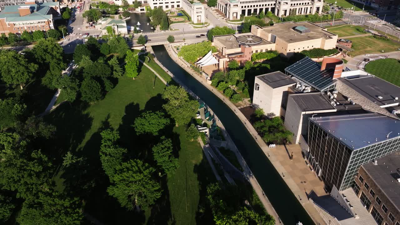 High birds eye drone shot slowly moving backward over White River Canal and nearby green spaces