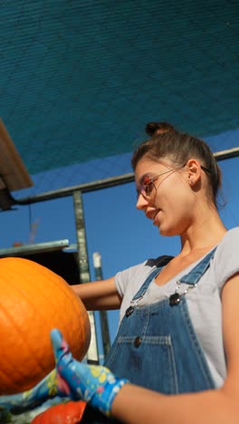 woman harvesting a pumpkin