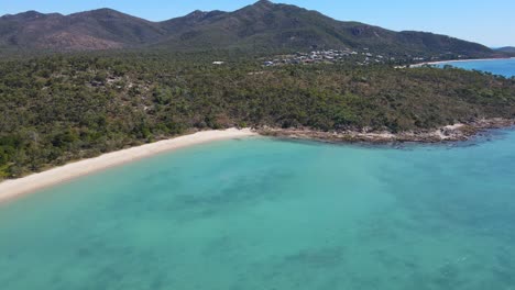 Turquoise-Blue-Water-And-Lush-Green-Island-Of-Dingo-Beach-In-Whitsunday-Islands,-North-Queensland,-Australia