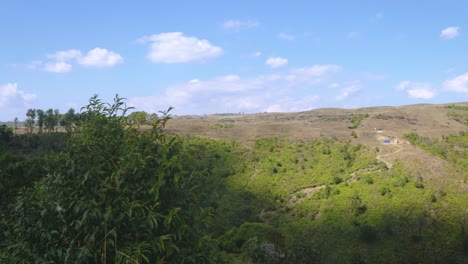 green-grass-countryside-mountains-with-bright-blue-sky-at-day