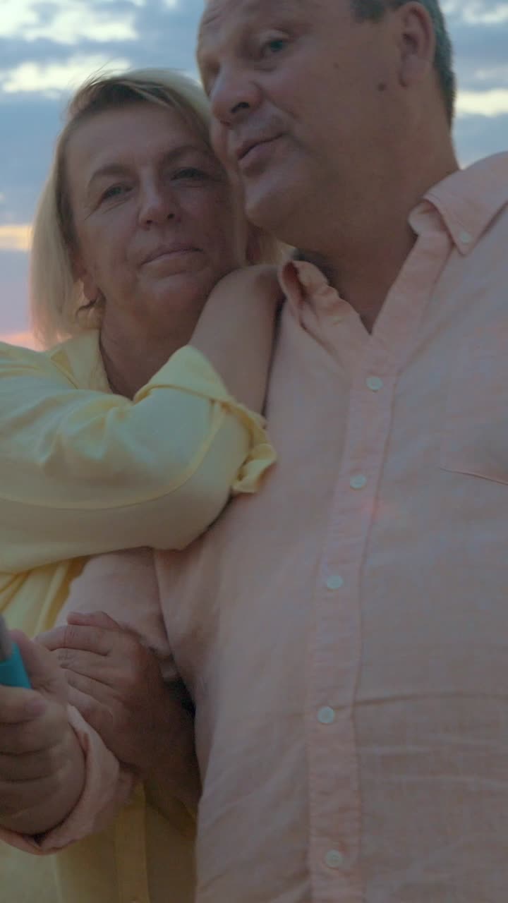 Loving Elderly Couple Enjoying Sunset at the Beach