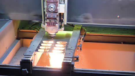 cnc milling machine in action, producing metal frames with precision in a factory in jiangsu province, china, as sparks fly from the cutting process.
