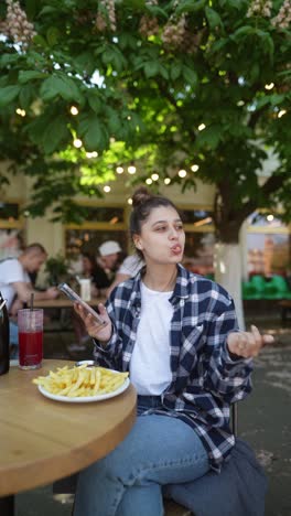 young woman enjoying lunch in outdoor cafe