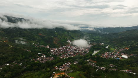 vista aérea de la ciudad de san rafael en la nublada colombia - órbita, disparo de avión no tripulado