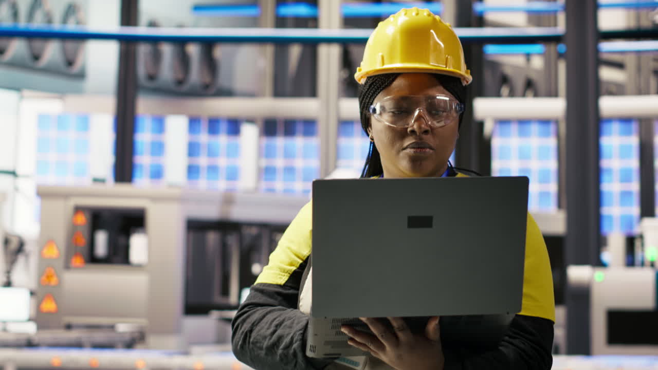 Vertical video Solar panels factory engineer analyzing data from IoT sensors