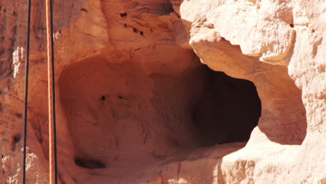 Rope-hanging-under-researchers-on-rappel-at-sandstone-cliff,-home-of-lear's-macaw