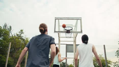 Redhead-Man-dribbles-in-a-basketball-game,-he-tries-to-hit-the-basket,-but-he-fails.-His-team-support-him-and-they-try-again