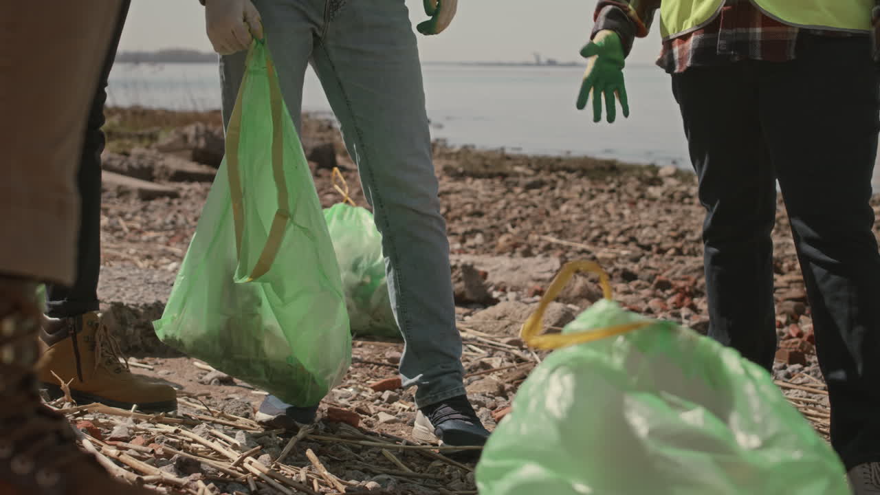 Group of Environmental Activists Speaking on Shore after Cleanup