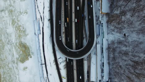 Car-driving-on-highway-junction-at-winter.-Aerial-view-cars-traffic-on-road