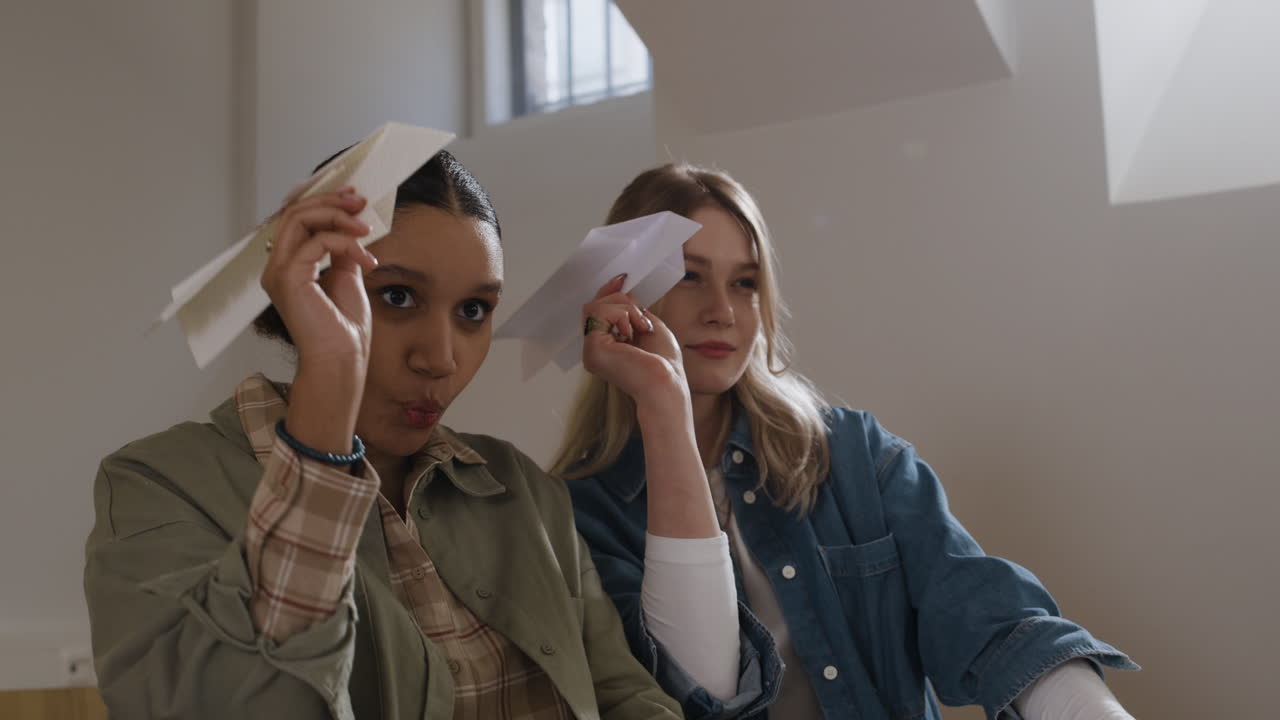 Two women with paper airplane