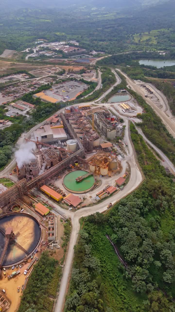 Gold and silver mine in Cotui, mining operations and land, Dominican Republic. Aerial drone panoramic view, vertical format
