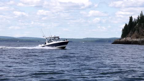 open ocean fishing boat returns to marina wake and white wash kick up in slow motion