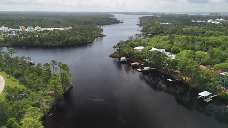 aerial view of a river flowing through a residential and wooded area, panama city beach, florida, usa