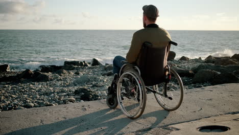 man in wheelchair at the beach