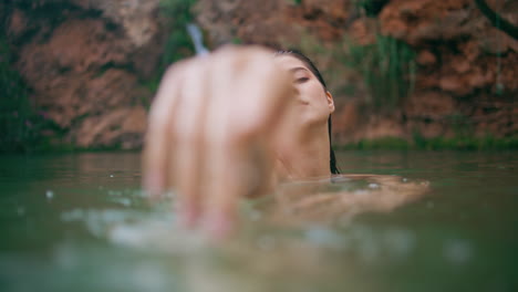 seductive model posing lake portrait. young woman looking camera moving arms