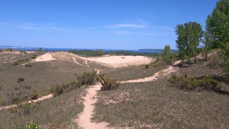 popular sleeping bear dune near one of the great lakes on sunny day