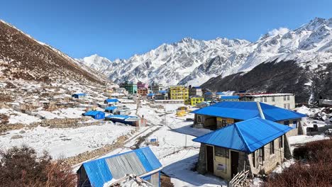 blue roof tops and colourful houses inside icy valley hihg altitude valley of kyanjin gompa